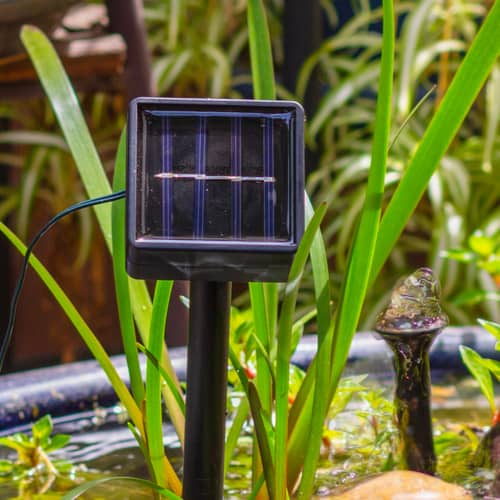 Solar panel being used to charge and power sphere water feature