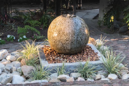 Large sphere water feature sat on pebbled base