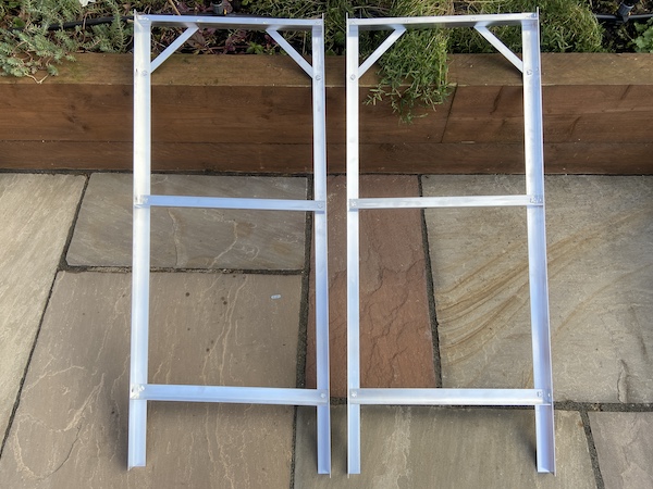Two side panels of Tibshelf Garden Products Greenhouse Staging assembled