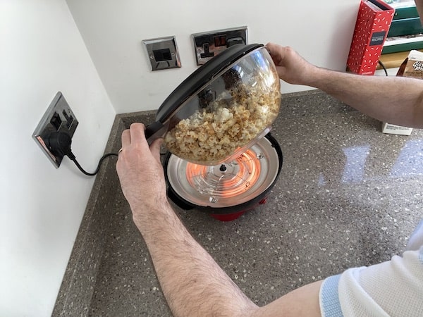 Flipping hot plate over so popcorn in in bowl ready to serve