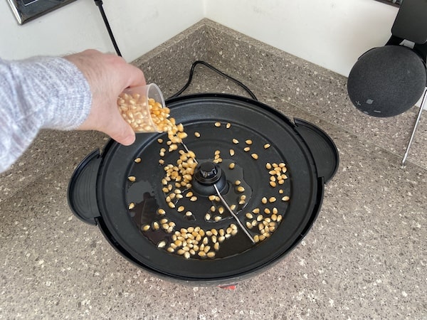 Pouring 100ml of kernels onto the hotplate