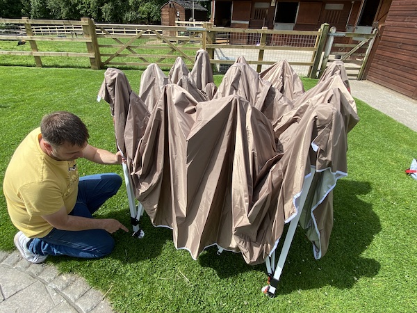 Pegging one corner of the gazebo down to make it easier to put up on my own