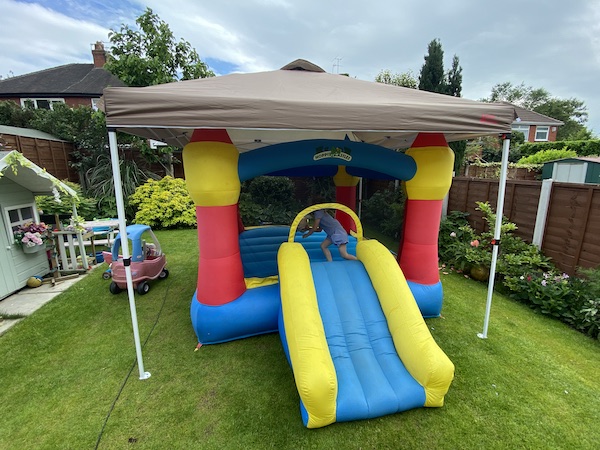 Using one of my pop up gazebos to cover the bouncy castle to provide some shade for the kids